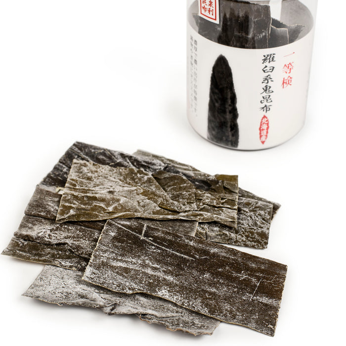 Several Rausu Oni Kombu sheets next to the package of the product