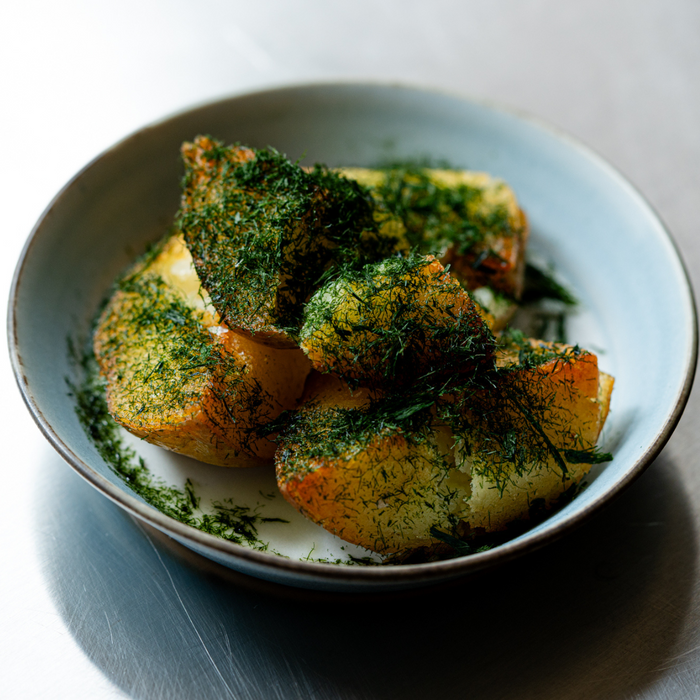 A bowl of fried potatoes topped with dried aonori