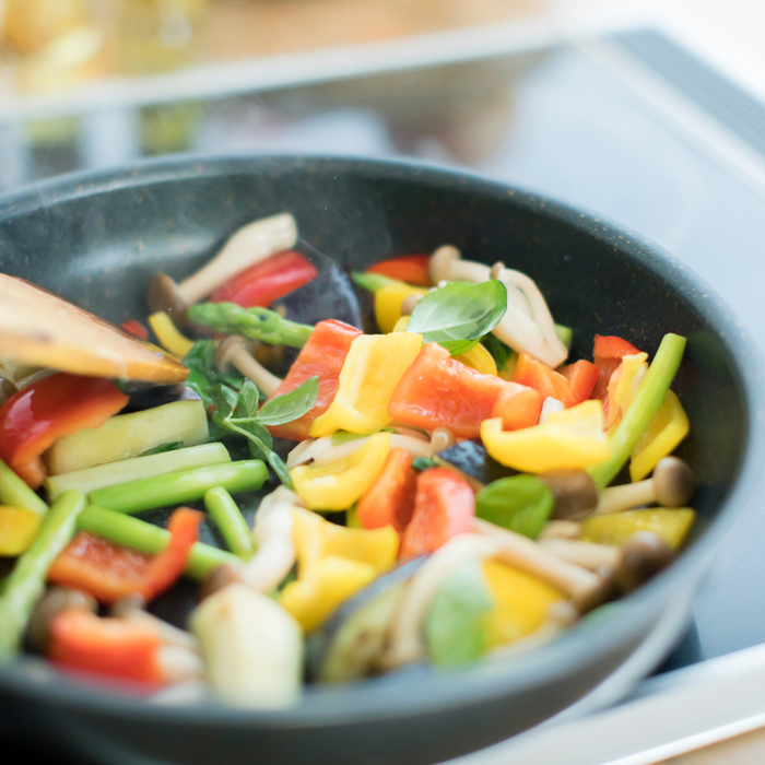 Stirring frying veggies on a pan