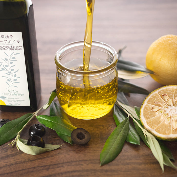 A man pouring yuzu extra virgin olive oil on to a jar