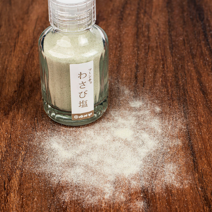 Scattered wasabi salt next to package bottle of the product