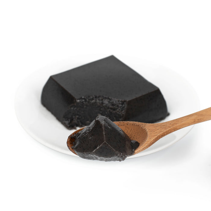 A spoon of black sesame tofu
