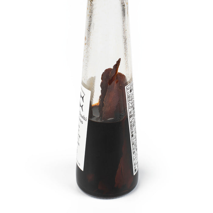 A bottle of soy sauce and bonito flakes