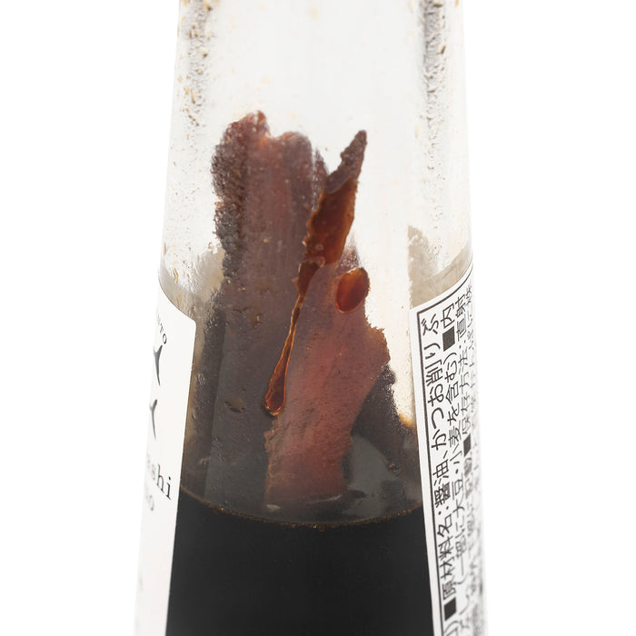 A bottle of soy sauce and bonito flakes - close up