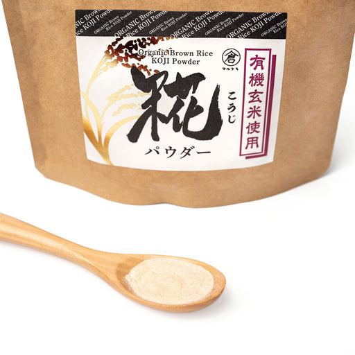 A spoon of organic brown rice koji  powder next to package of the product