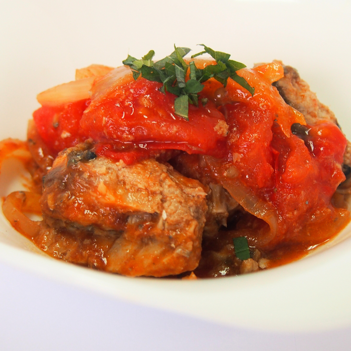 A plate of grilled chicken with tomato ketchup sauce