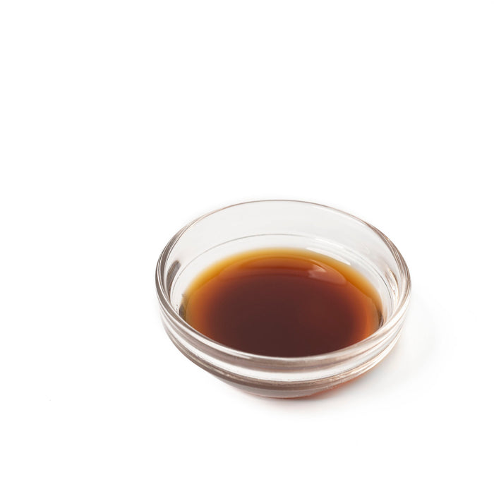 A glass bowl of yuzu infused tamari soy sauce