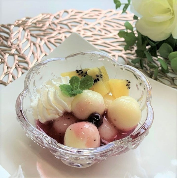 A bowl of shiratama dango with cream cheese and sliced kiwi