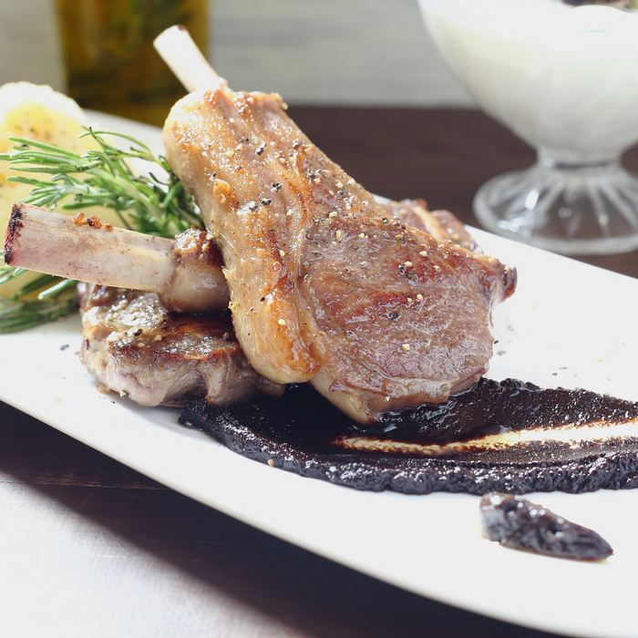 A plate of pork chop with black garlic sauce