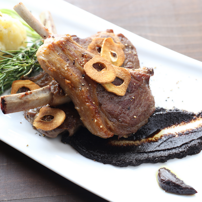 A plate of pork chop topped with garlic chips