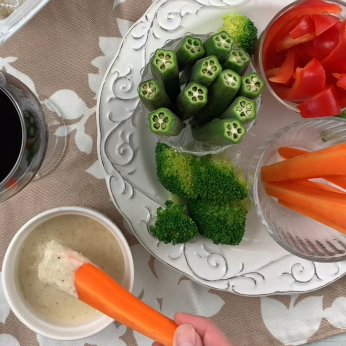 Man dipping carrot into shiitake dipping sauce
