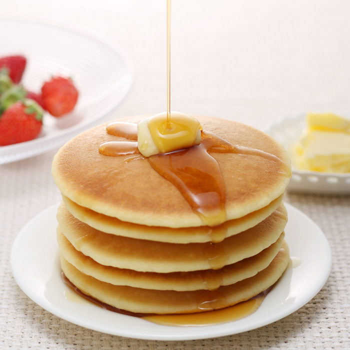 A plate of rice flour pancakes with honey and butter