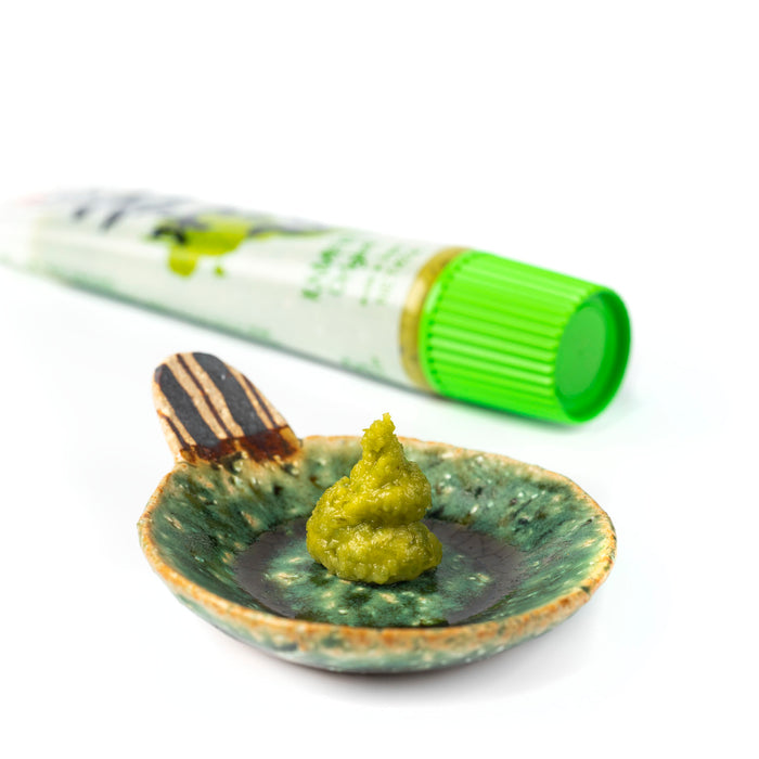 A small bowl of hon-wasabi next to wasabi tube