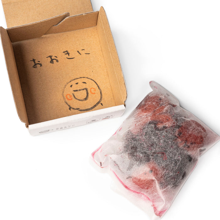 An internal package of organic umeboshi next to the package box with a hand-written thank you message