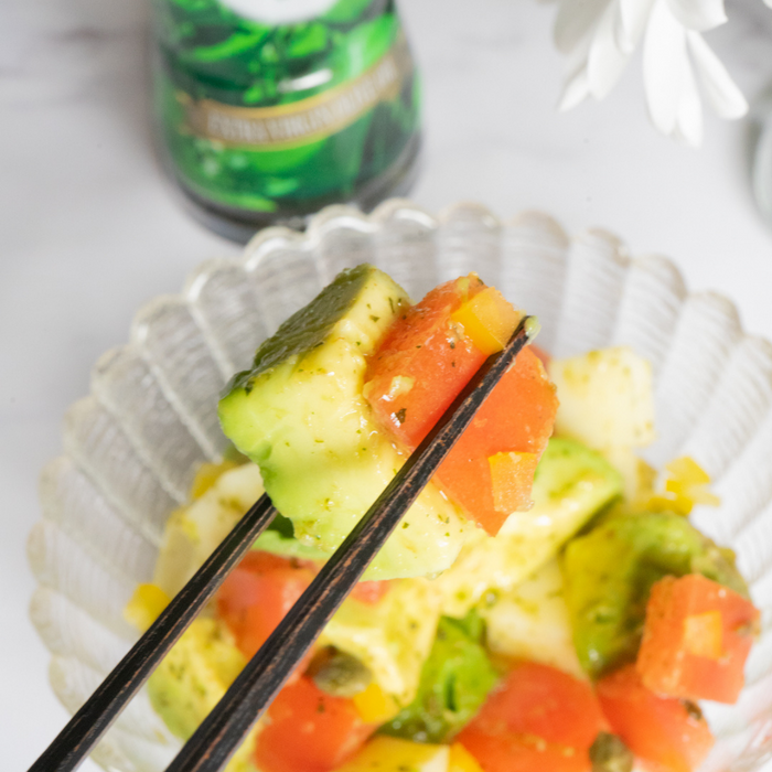 Man taking avocado carpaccio with chopsticks
