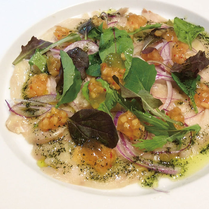 A plate of carpaccio with wasabi olive oil
