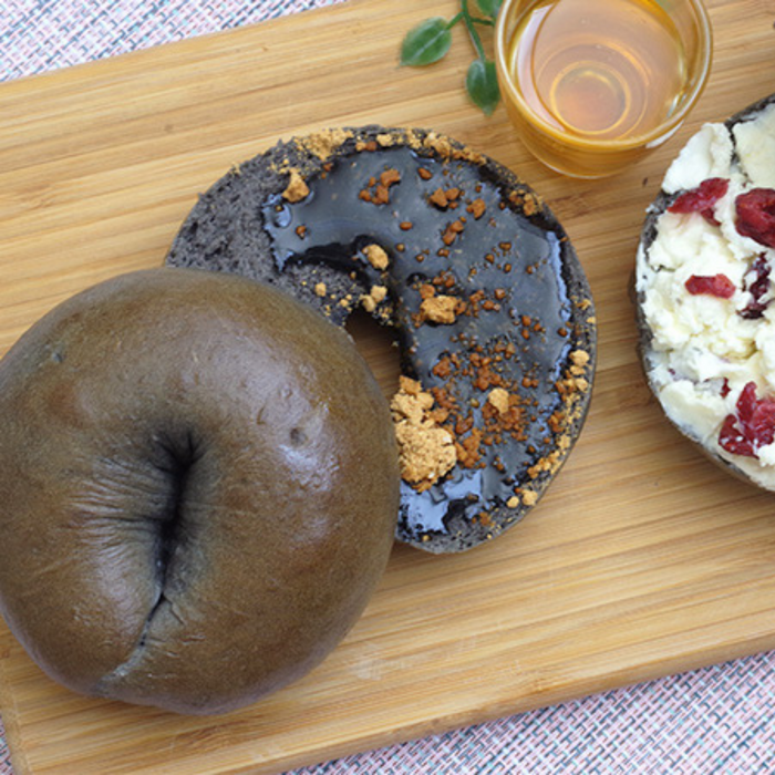 Black sesame blended bagels on cutting board