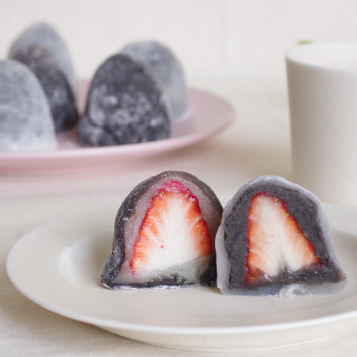 Half cut of strawberry stuffed black sesame latte mixed mochi