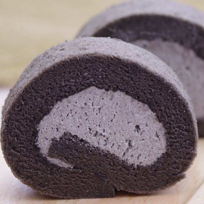 Pound cake stuffed with black sesame cream on a cutting board