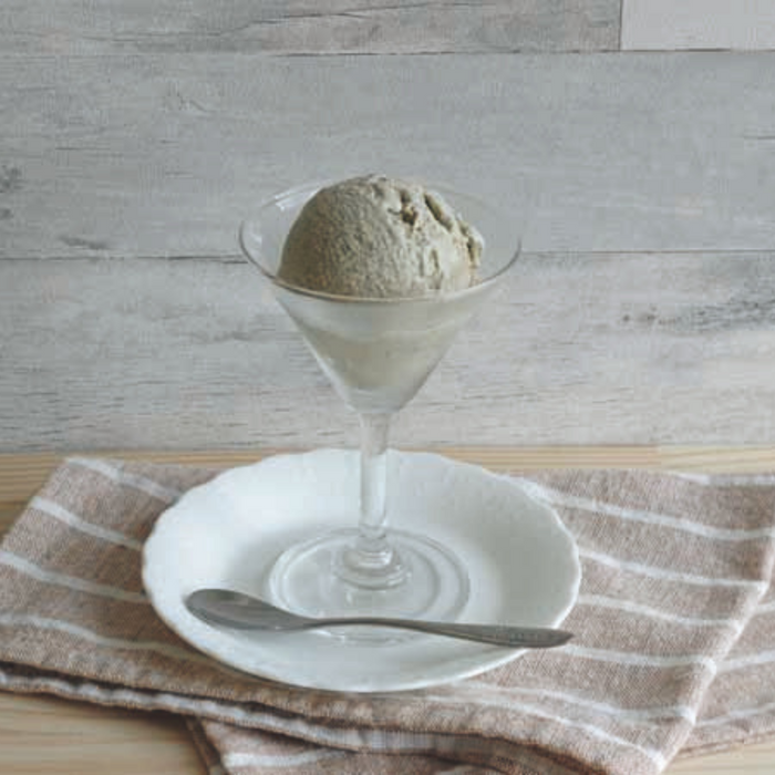 A scoop of black sesame ice cream on cocktail glass