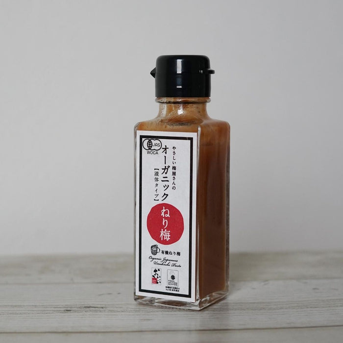 A bottle of the product standing on wooden table
