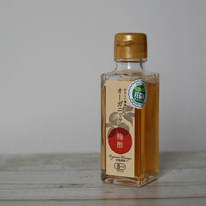 A bottle of the product standing on wooden table