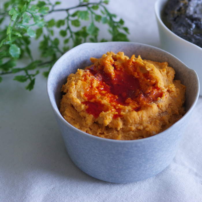 A bowl of hummus topped with rayu