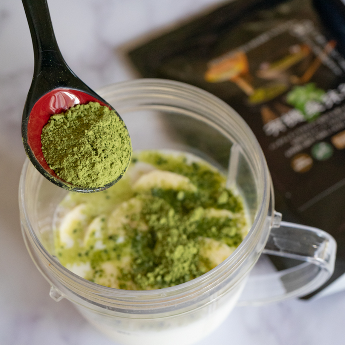 Man adding mulberry matcha to yogurt with spoon