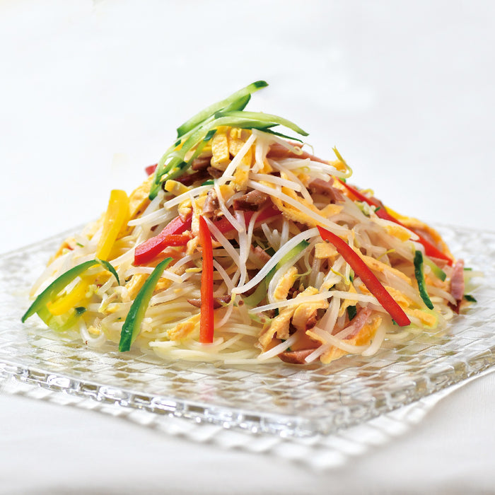 A plate of gluten free cold ramen noodles with mixed vegetables and shredded omelette