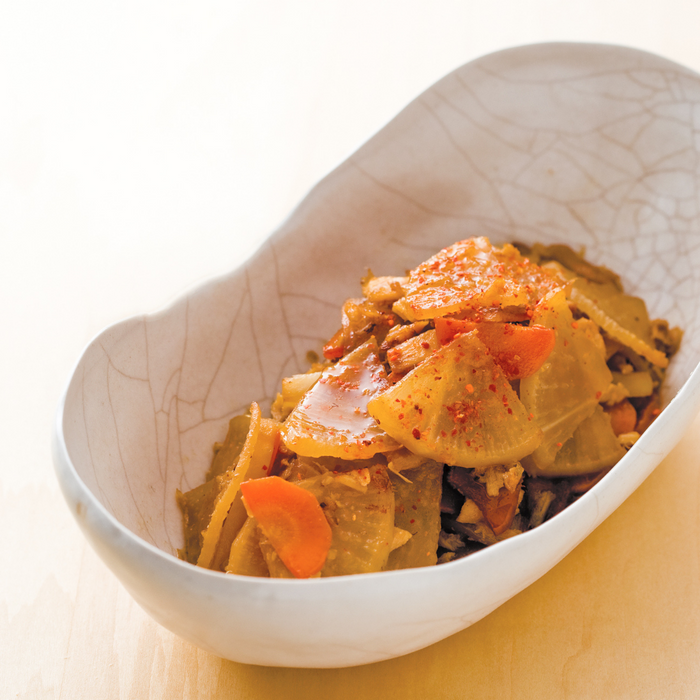 A bowl of stewed vegetables topped with ichimi pepper