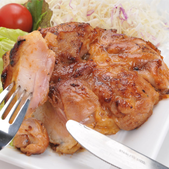 Man taking a piece of grilled chicken with folk