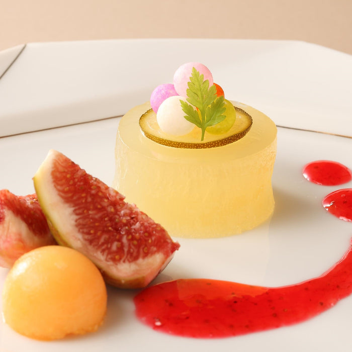 A plate of yuzu blended jelly with fresh figs and berry sauce