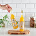 Two bottles of citrus syrup placed on cutting board