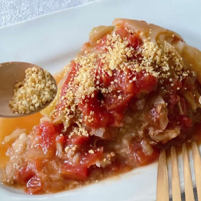 Tomato dish topped with vegan parm