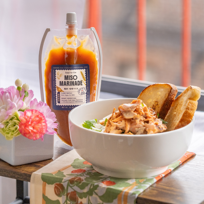 miso marinated chicken on top of a salad bowl