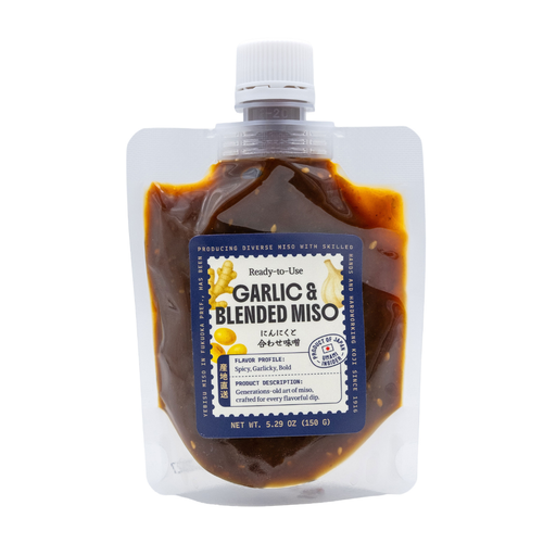 Packaged garlic and blended miso on a white background