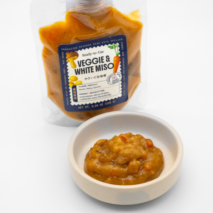 Packaged Veggie & White Miso with a small bowl of the product on a white background