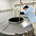 Man stirring vinegar using a stick