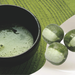 Three matcha milk hard candies and a bowl of matcha