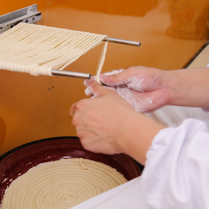 Man knitting udon noodles