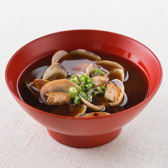A bowl of miso soup with clams
