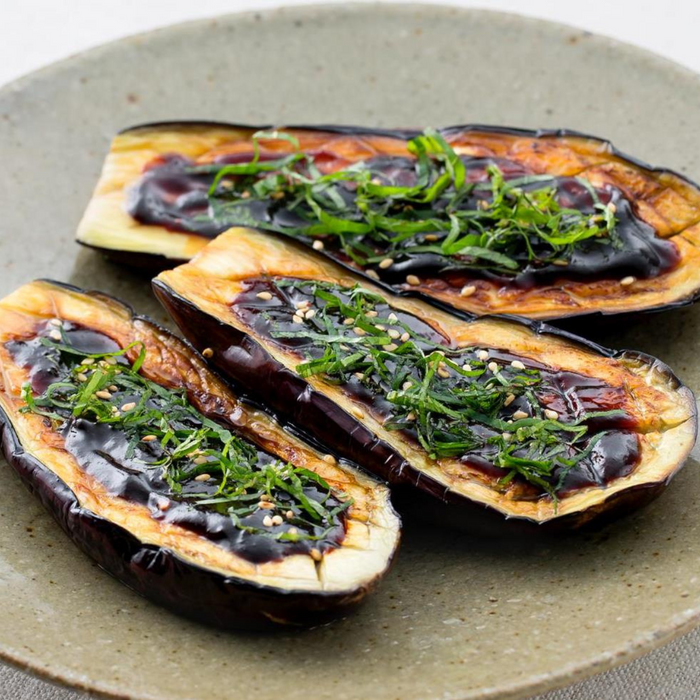 A plate of three grilled eggplants