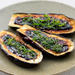 A plate of three grilled eggplants