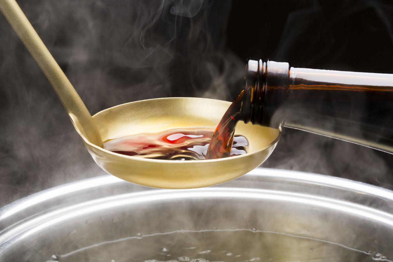 Pouring soy sauce onto ladle