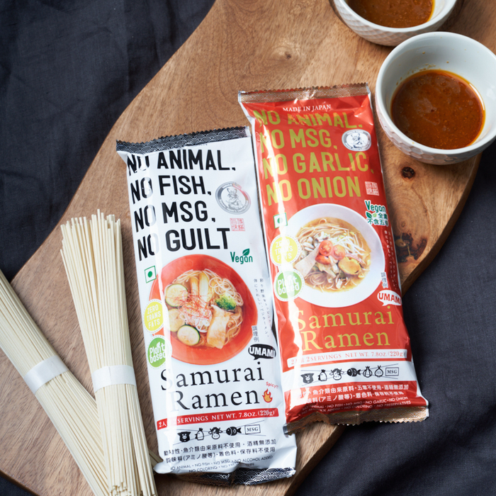 Two ramen noodles kits on cutting board