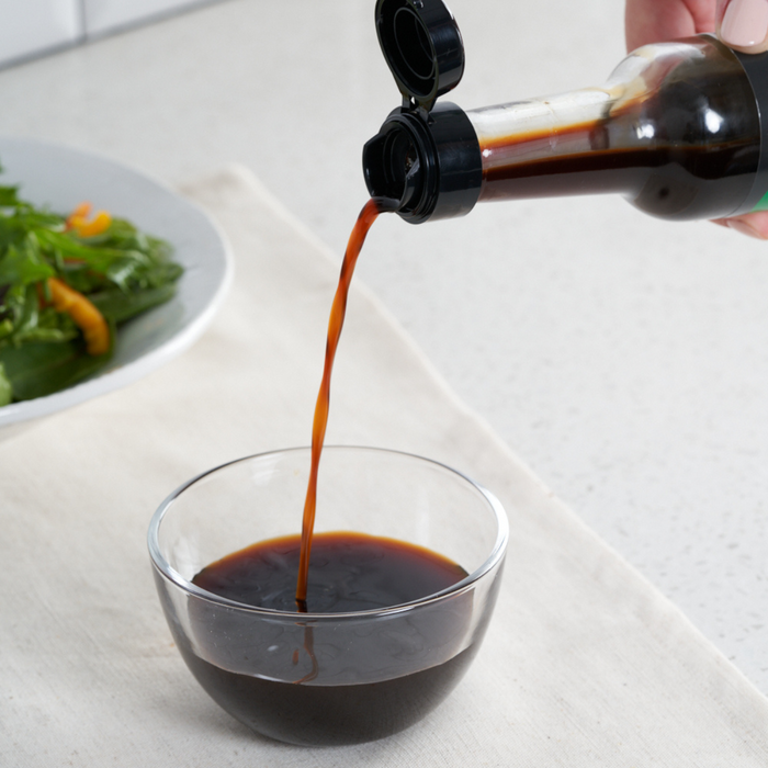 Man pouring organic ponzu into a bowl