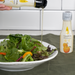 Man pouring yuzu flavored oil onto a salad bowl