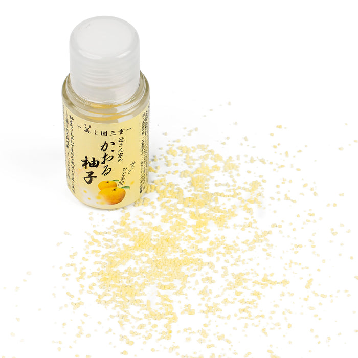 Scattered powdered yuzu seasoning next to a package bottle of the product