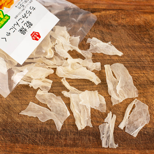 Dried konjac noodles popping out of a bag of the product