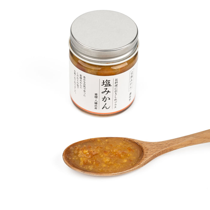A spoon of mikan mandarin sauce next to a package jar of the product